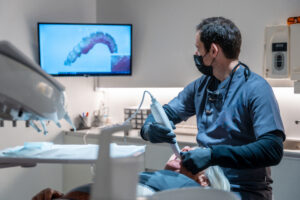 Dentist using intraoral scanner in a modern digital dentistry workflow